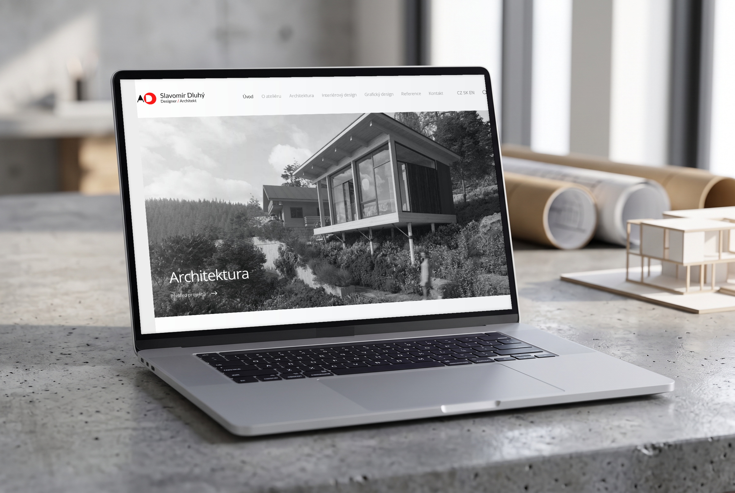 Atelier Dluhý — náhled webu v mockupu MacBooku